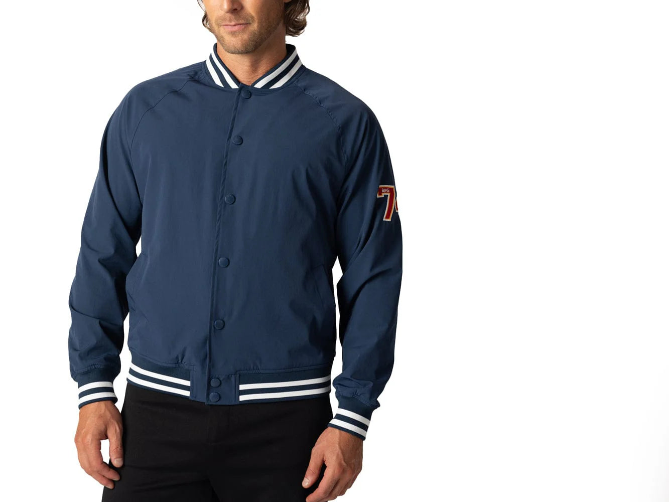 Blue vintage Varsity Bomber Jacket includes tackle twill "74" on the left sleeve, rib-knit collar and cuff, snap front closure, front hand pocket and interior chest pocket, and interior mesh lining.