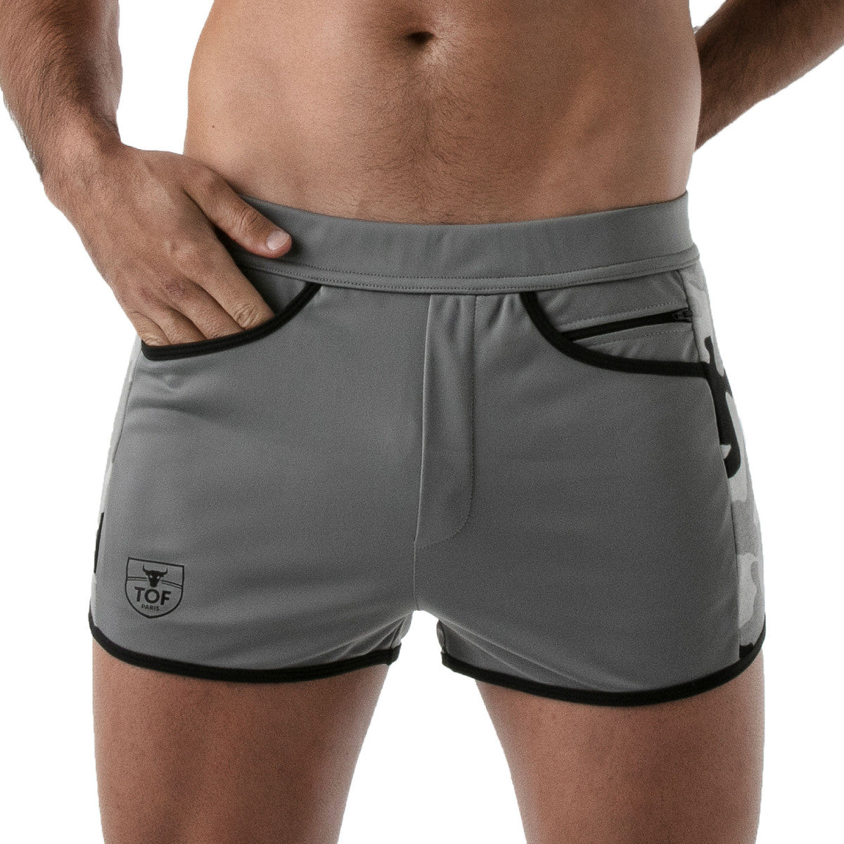 TOF's low-waisted, grey sport shorts have camouflage patterned sides, black outline, and pockets including an additional zipper pocket. The shorts are made of antibacterial microfiber.