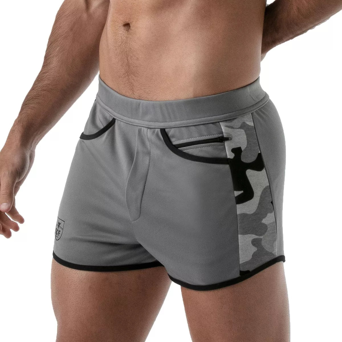 TOF's low-waisted, grey sport shorts have camouflage patterned sides, black outline, and pockets including an additional zipper pocket. The shorts are made of antibacterial microfiber.